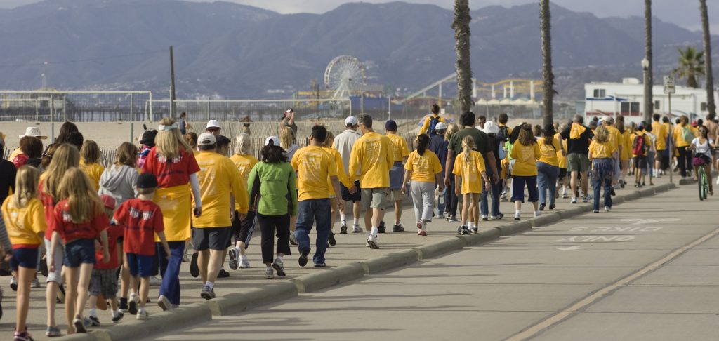 Groups of people wearing support t-shirts walk down the Santa Monica Beach during the 20th Annual Westside Food Bank Hunger Walk on Sunday afternoon. The locally sponsored event raises money and food for people in need of food and other services.
